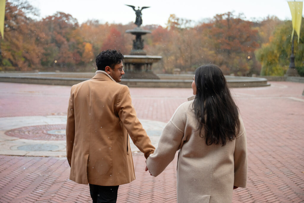 couple walking toward the angle fountain in Central Park, NYC
