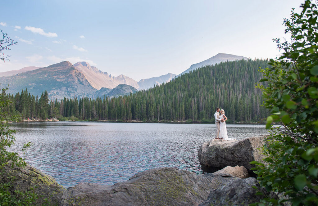 Mountain view with lake and bride and groom, Estes Park, Rocky Mountain National Park
